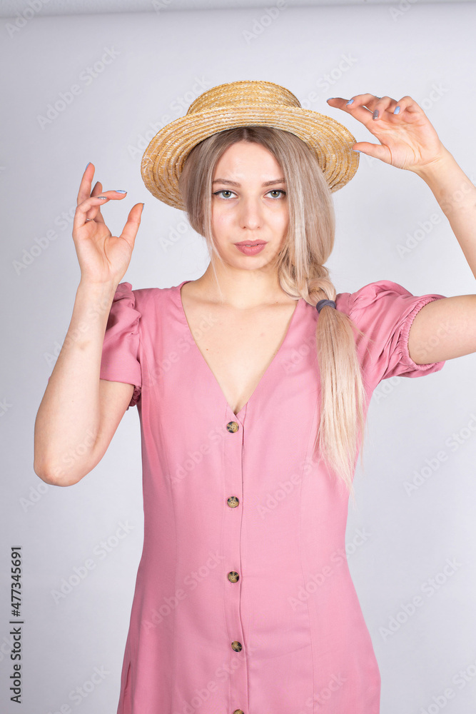 Woman with blonde hair and white skin isolated on grey in pink clothes Woman with blonde hair and white skin isolated on grey in pink clothes
