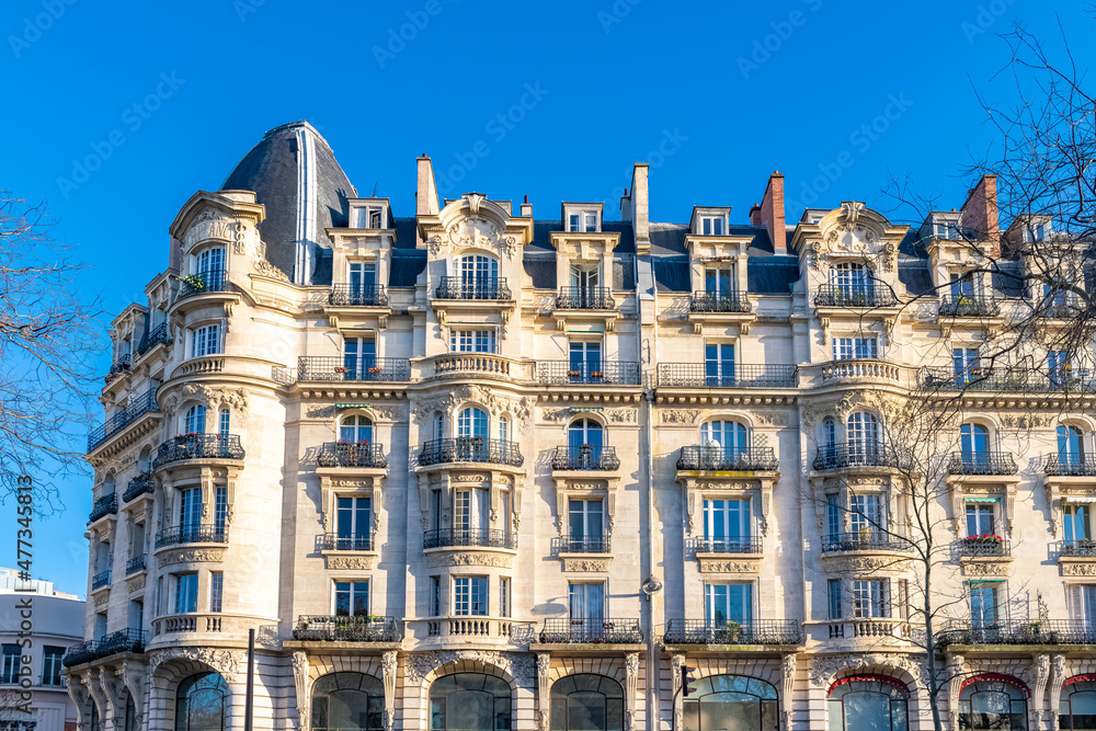 Paris, typical facade and dome, beautiful building boulevard Richard-Lenoir, with a public park
