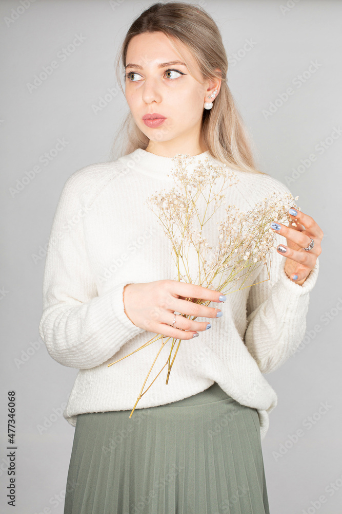 Romantic woman with long hair and white skin isolated on grey in white sweater Romantic woman with long hair and white skin isolated on grey in white sweater