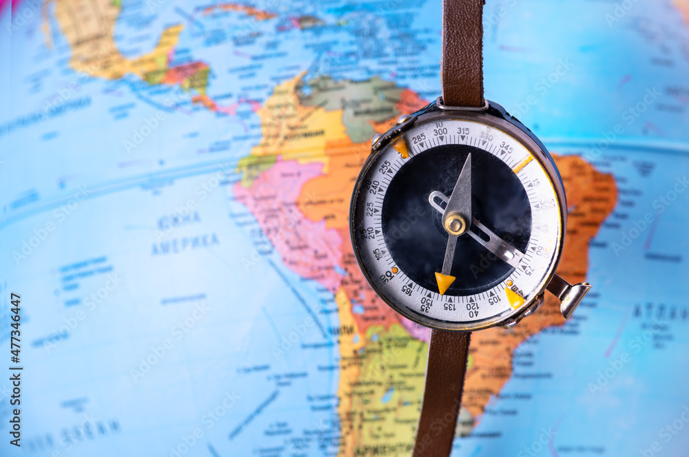 Compass on top of world map. Magnetic compass on world map. Stock Photo ...