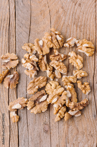 Peeled walnuts on wooden background