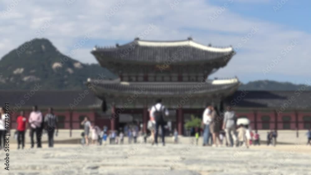 Defocused shot of tourits visit Geunjeongjeon hall, the entrance of Gyeongbokgung Palace, seoul, South Korea. Blurred background in the scene Defocused shot of tourits visit Geunjeongjeon hall, the entrance of Gyeongbokgung Palace, seoul, South Korea. Blurred background in the scene