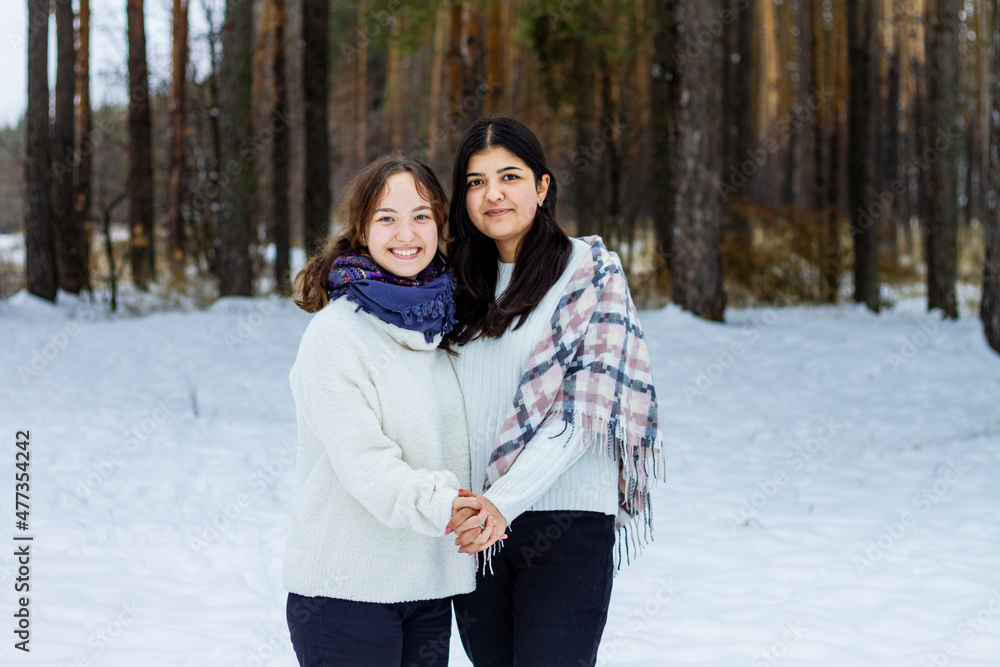 Winter, two girls hug each other against the backdrop of a winter forest, cold, snow, fun. Winter, two girls hug each other against the backdrop of a winter forest, cold, snow, fun.