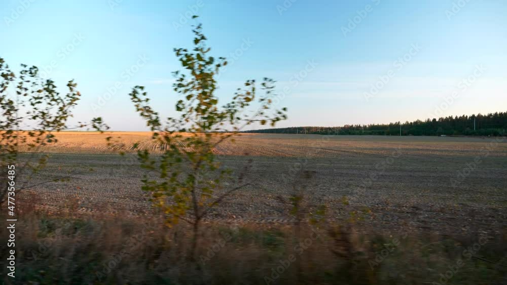 Plowed Field after Harvest. View out of Car Window. Autumn Season. Evening Sunset. Europe Rural Scene Background. 2x Slow motion 60fps 4K Plowed Field after Harvest. View out of Car Window. Autumn Season. Evening Sunset. Europe Rural Scene Background. 2x Slow motion 60fps 4K