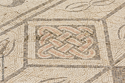 Ornate ancient roman floor mosaic wih geometrical patterns in Archeological excavation of the ruins of Italica, Roman city in the province of Hispania Baetica near the current village of Santiponce,  photo