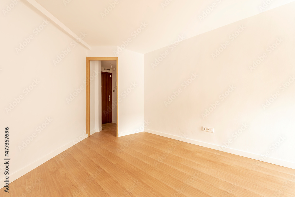 Empty room with freshly painted walls and oak wood flooring Empty room with freshly painted walls and oak wood flooring