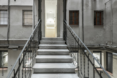 Interior stairs in the patio of lights of a vintage building © Toyakisfoto.photos