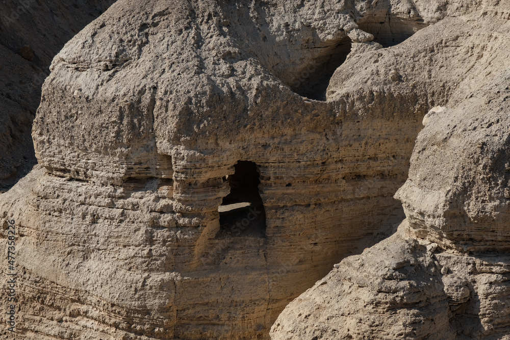 View of the Qumran caves at Wadi Qumran in the Judean desert, the famous caves where the Dead Sea Scrolls were discovered, Qumran National Park, Israel.
