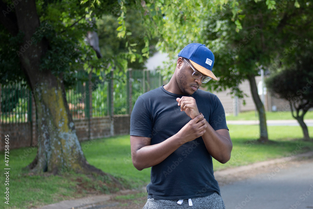 African Man Looking at his wrist band African Man Looking at his wrist band