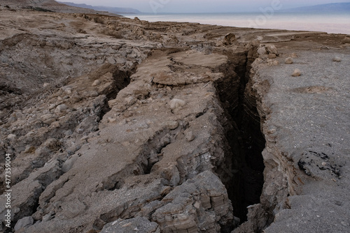 View of Dead Sea sinkholes (or swallows), a deep hole in the ground formed abruptly along the coastline of the Dead Sea, Ein Gedi, Israel. 