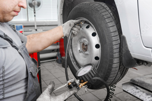 Cheking air pressure in automobile car wheel after tyre fitting or tire replacing for winter type