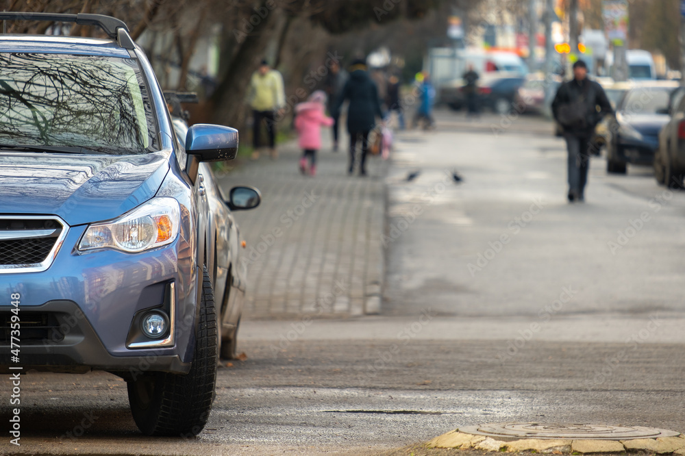 Fototapeta premium Cars parked in a row on a city street side