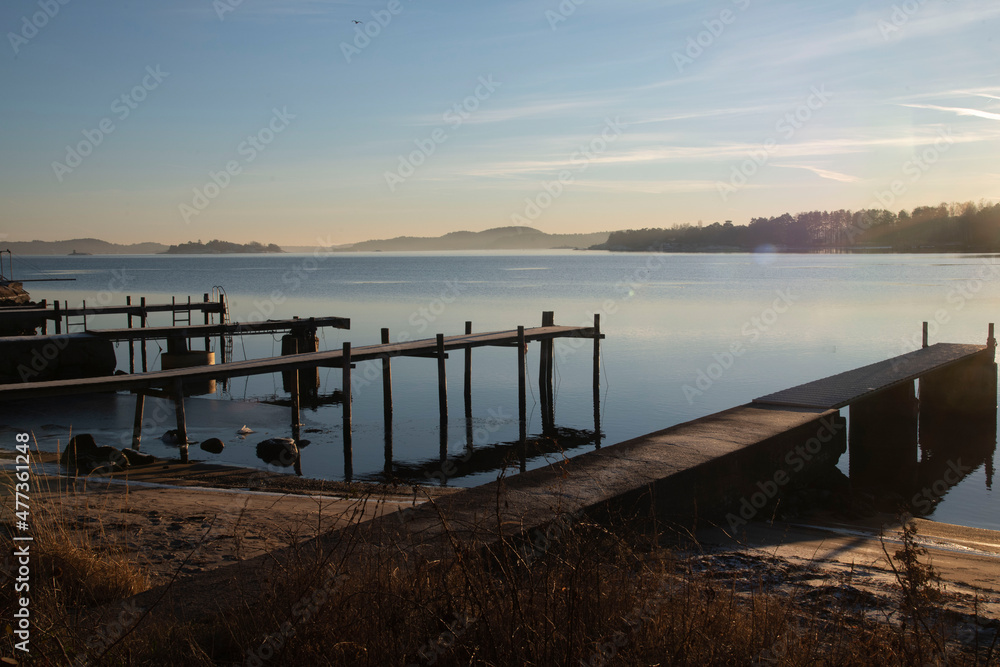 Fototapeta premium sunset on fjord with pier 
