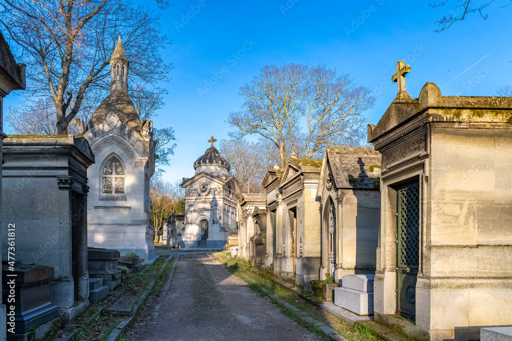 Paris, the Pere-Lachaise cemetery, cobbled alley with graves in winter
