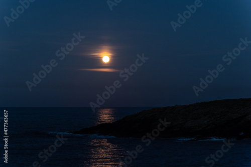 Full moon on the coast of Galicia, with lighthouse, natural rock arches, etc!
