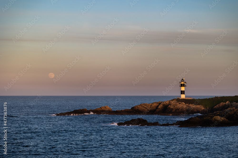 Full moon on the coast of Galicia, with lighthouse, natural rock arches, etc!