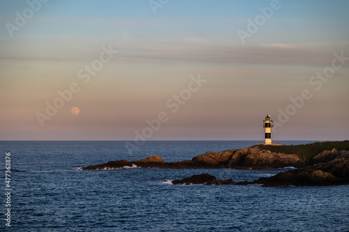 Full moon on the coast of Galicia, with lighthouse, natural rock arches, etc! © AGUS