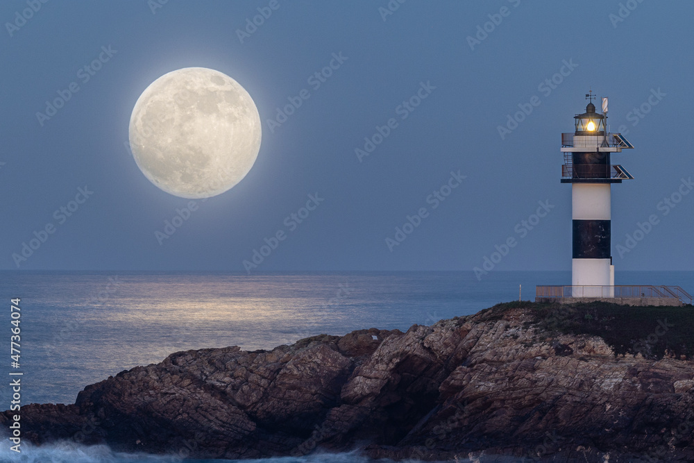 Full moon on the coast of Galicia, with lighthouse, natural rock arches, etc!