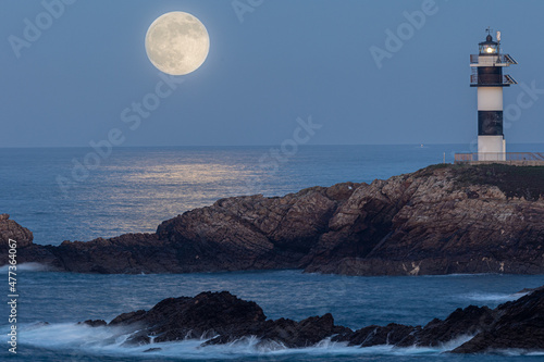 Full moon on the coast of Galicia, with lighthouse, natural rock arches, etc!