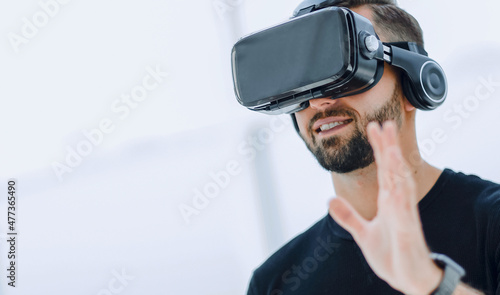 portrait of an amazed guy using a virtual reality headset isolat photo
