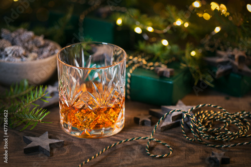 Glass of whiskey or bourbon with Christmas decoration