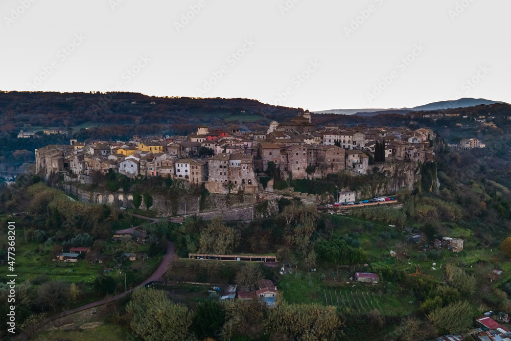 Aerial view of Orte, a small town on hilltop along the Tiber river at sunset, Viterbo, Italy. Aerial view of Orte, a small town on hilltop along the Tiber river at sunset, Viterbo, Italy.