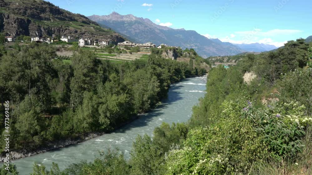 Beautiful late afternoon sight of the Dora Baltea river near Aosta. Aosta Valley, northern Italy. Beautiful late afternoon sight of the Dora Baltea river near Aosta. Aosta Valley, northern Italy.