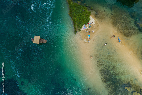 Aerial view of a small sailing boats for touristic tours navigating the Una river, Lohovo, Bosnia and Herzegovina. photo