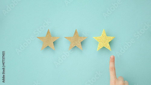 Hand of client giving a three star rating. Service rating, satisfaction concept