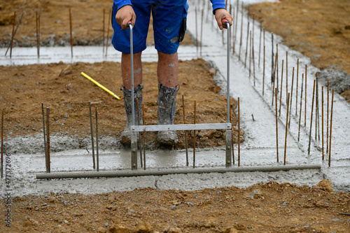 Worker on a construction site working with concrete