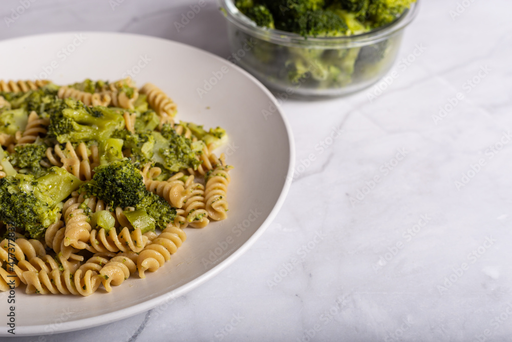 Fusilli pasta with broccoli on a white background. Typical vegetarian food. Fusilli pasta with broccoli on a white background. Typical vegetarian food.
