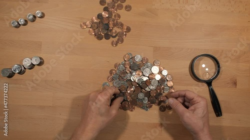 A man sorting and counting coins photo