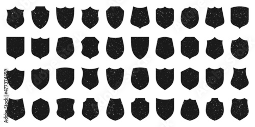 Set of various vintage shield icons. Black heraldic shields with grunge texture. Protection and security symbol, label. Vector illustration.