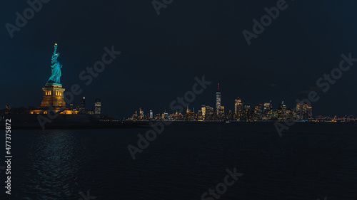 Statue of Liberty by night with Manhattan
