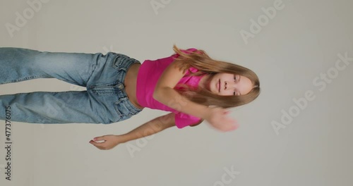 Vertical video of dancing teen girl cool moving. Energetic child dance hip hop, recording content for social network