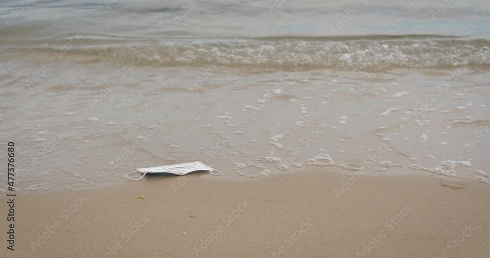 Ocean mask pollution in sea. A view of polluted ocean water with personal mask during pandemic. Ocean mask pollution in sea. A view of polluted ocean water with personal mask during pandemic.
