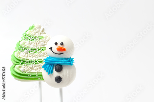 Confectionery sugar tree and snowman for decorating cakes on a white background with copy space.