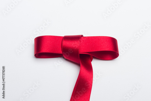 Red ribbon for gift wrapping on a white background