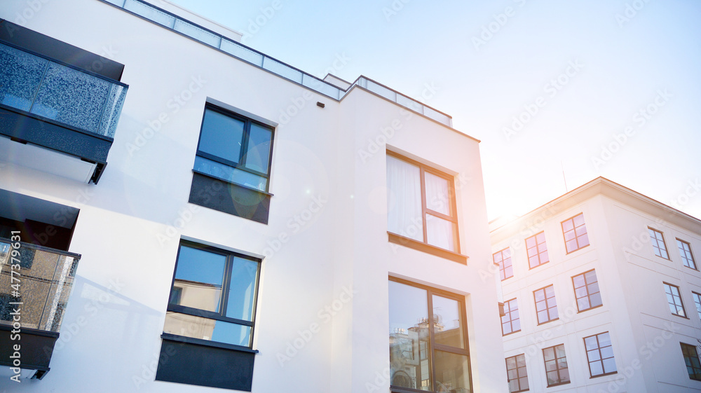  Facade of a modern apartment condominium in a sunny day. Modern condo buildings with huge windows and balconies.