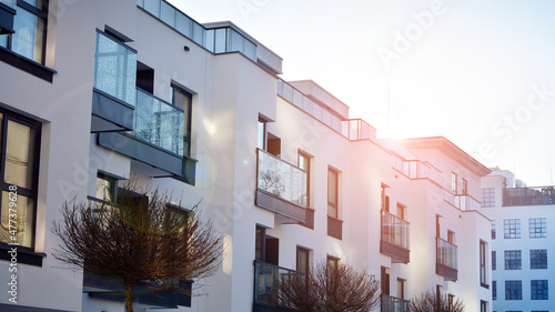  Facade of a modern apartment condominium in a sunny day. Modern condo buildings with huge windows and balconies.