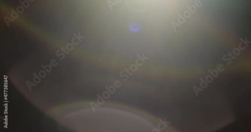 A pack of shining lens flares overlays on a black background. Slow motion. 