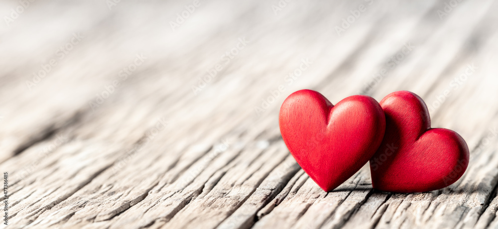 Two Red Wooden Hearts On Rustic Table - Valentine's Day Two Red Wooden Hearts On Rustic Table - Valentine's Day
