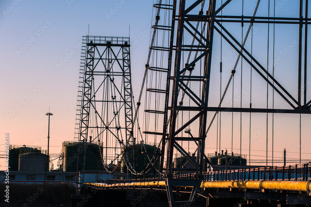 Oilfield pipeline bridge in sunset background Oilfield pipeline bridge in sunset background