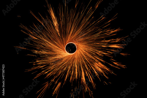Night fire dance. Sparks from steel wool on a black background. Close-up.