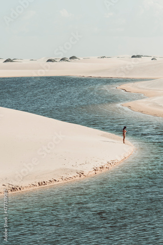 Lençóis Maranhenses - Silhouette of a girl in the dunes during summer in this brazilian national park photo