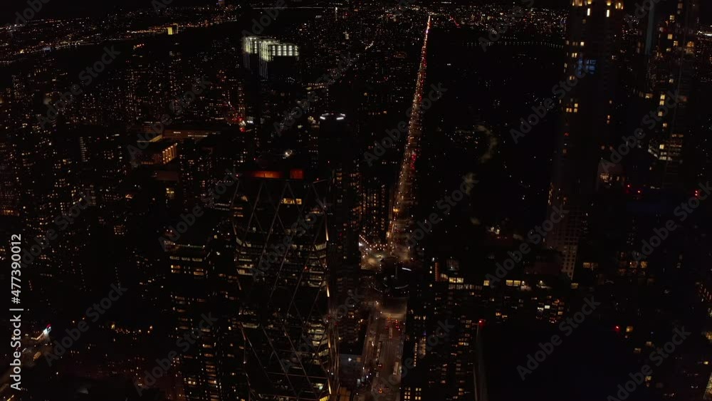 High angle view of night cityscape. Long straight street lit by car lights. Manhattan, New York City, USA High angle view of night cityscape. Long straight street lit by car lights. Manhattan, New York City, USA