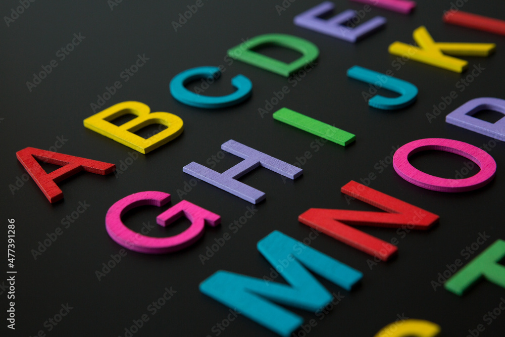 Colorful wooden english letters A-Z on black background