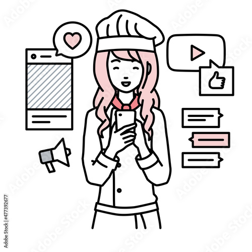 立ってスマートフォンでさまざまなSNSで楽しく交流する調理師の女性