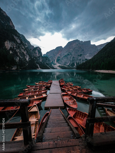 Brown wooden boats beside dock in a lake in The Fanes-Sennes-Prags Nature Park