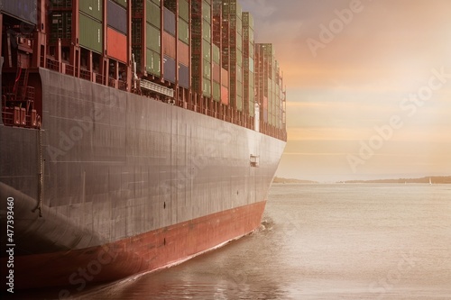 Cargo ship on sea during sunset photo